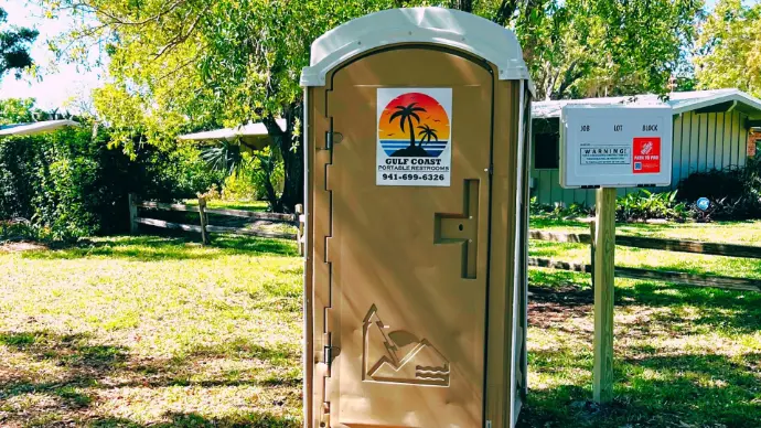 Heavy-duty porta potty unit on active commercial job site